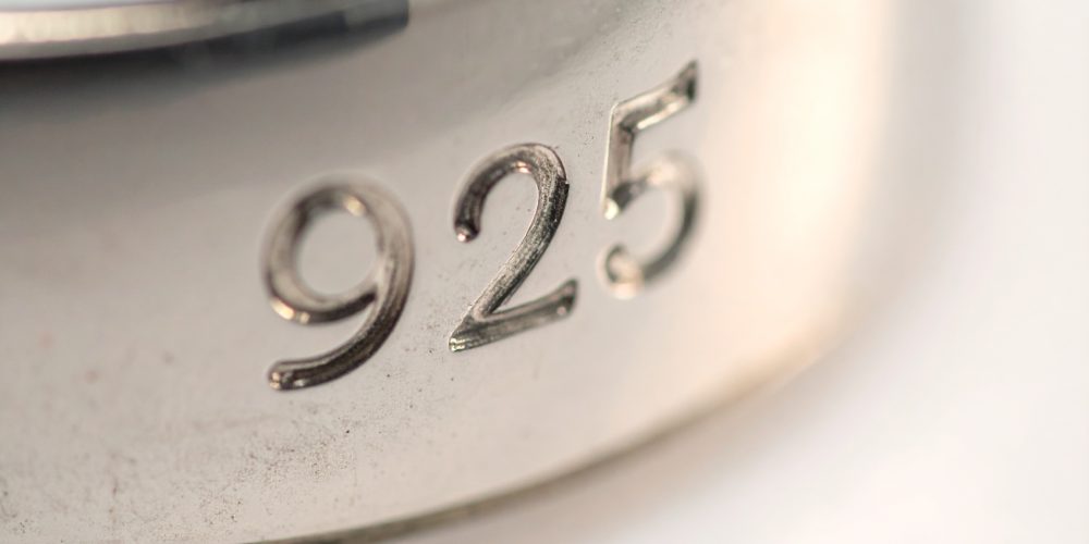 Firefly_Macro close-up photo of a 925 silver jewellery piece showing the engraved “925” hallm 168908